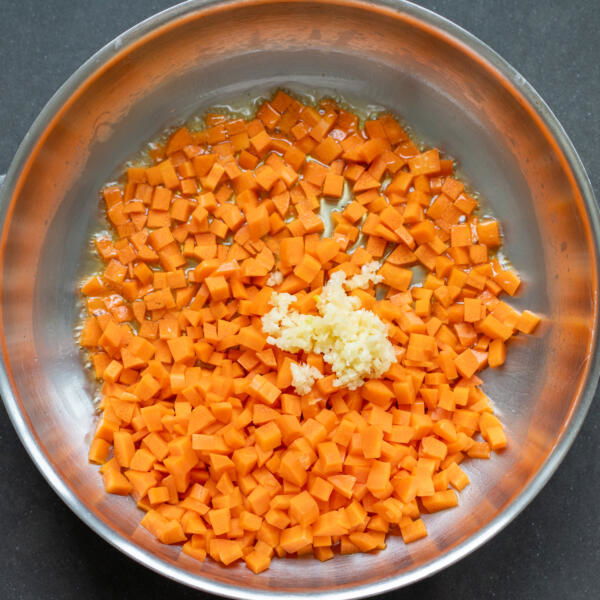 Carrots and garlic in a pan.