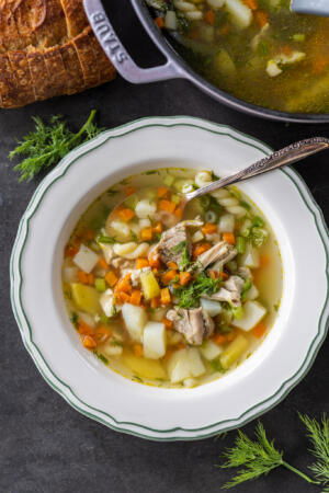 A bowl of Herbed Chicken Noodle Soup.