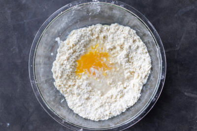 Egg and water added to the flour with butter.
