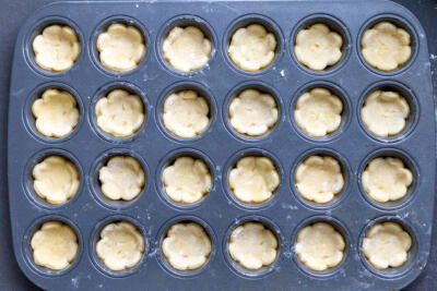 Cookie cutouts in a muffin pan.