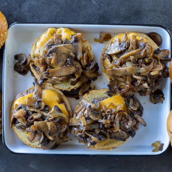 Burgers topped with mushrooms and onion mixture.