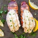 broiled lobster on a serving tray with lemon