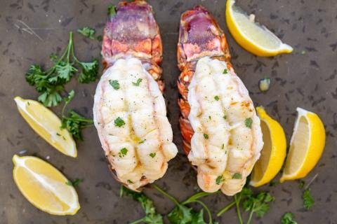 broiled lobster on a serving tray with lemon