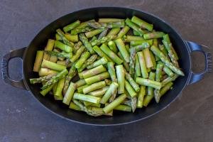 Sliced asparagus in a baking pan