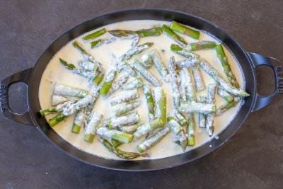 Creamy sauce with asparagus in a pan