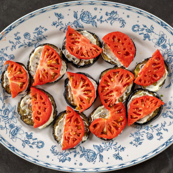 Eggplant with mayo and tomato slices.