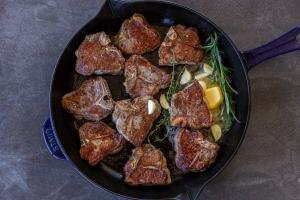 Browned Lamb Loin Chops in a pan with herbs