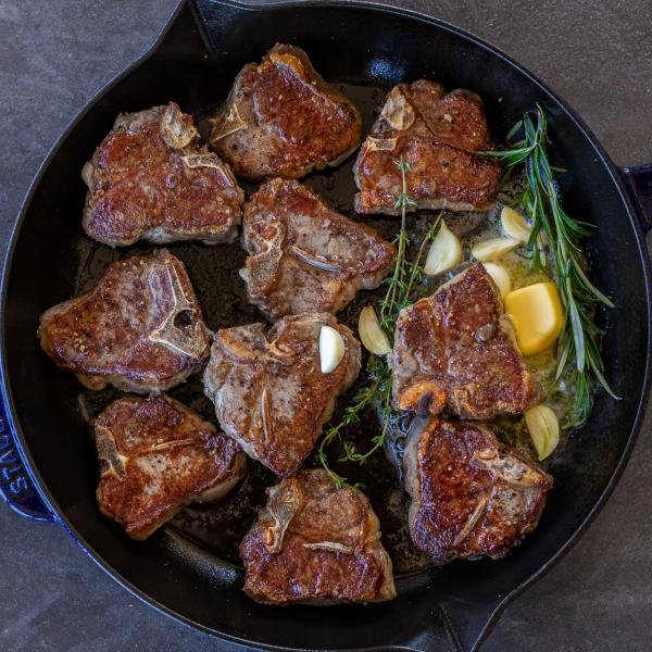 Browned Lamb Loin Chops in a pan with herbs