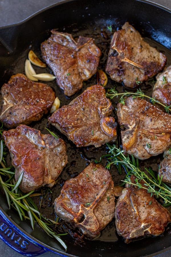 Browned Lamb Loin Chops in a pan with herbs