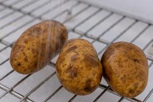 potatoes under running water