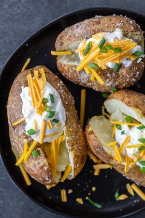 Baked potatoes with toppings on a plate