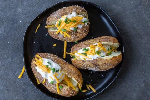Baked potatoes with toppings on a plate