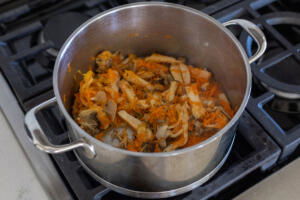 Mushroom, carrots and onion in a pot.