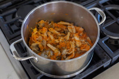 Mushroom, carrots and onion in a pot.