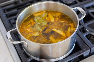 Pot of soup on a cook top.