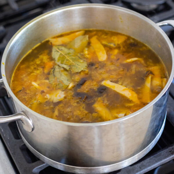 Pot of soup on a cook top.