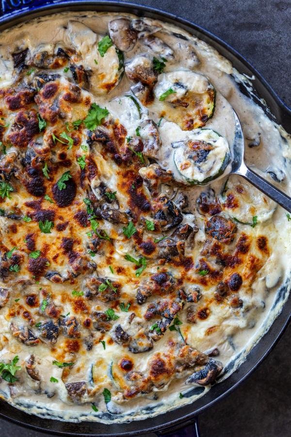 Zucchini Alfredo Bake in a pan with a spoon