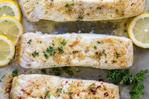 Baked halibut on a baking sheet.