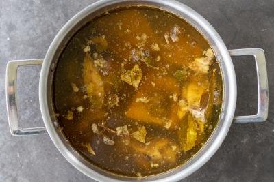 Broth in a pot with bones.