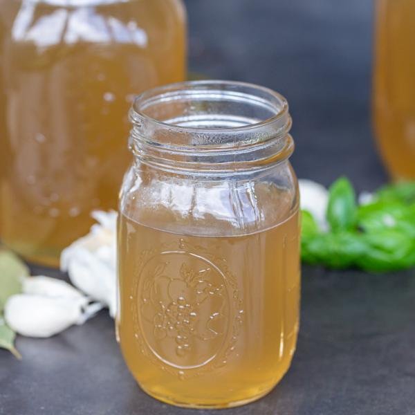 Bone Broth in jars with hers next to it.