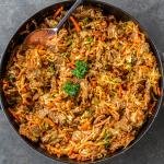 Braised Cabbage with Beef in a pan with spoon