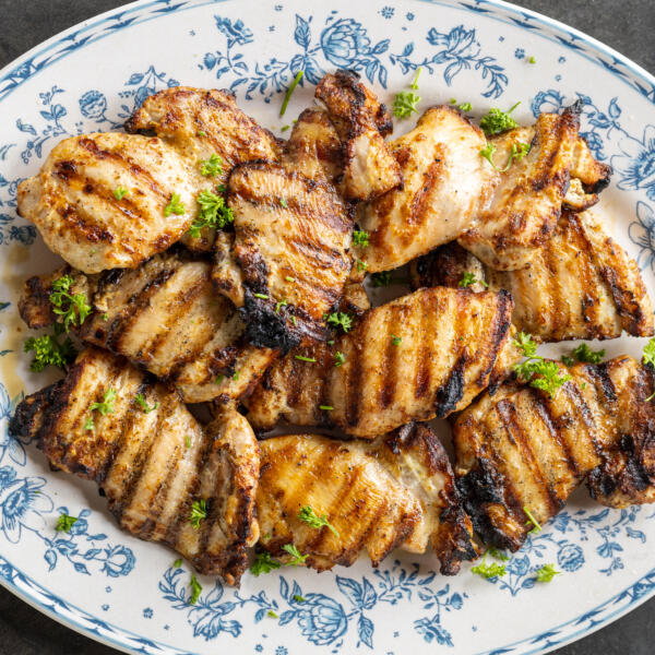 Grilled Chicken Thighs on a serving plate.