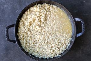 Rice and broth in a pan.