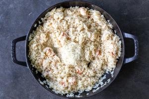 Parmesan cheese added to lobster risotto.