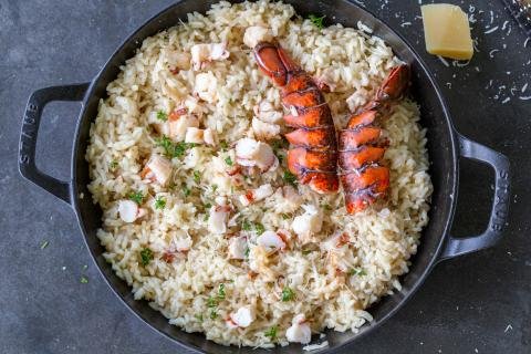 Lobster Risotto in a pan with lobster shell and parmesan.