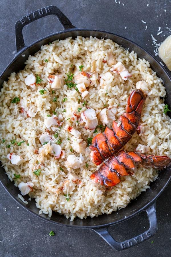 Lobster Risotto in a pan with lobster shell with parmesan on top. 