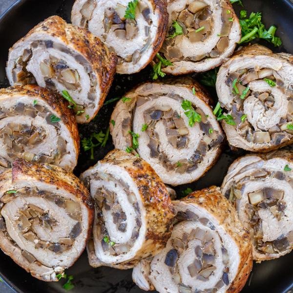Slices of pork roulade on a plate.