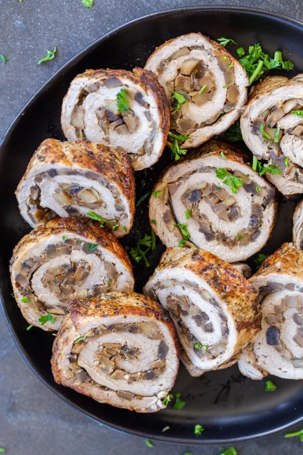 Mushroom Pork Roulade with herbs on a plate. 