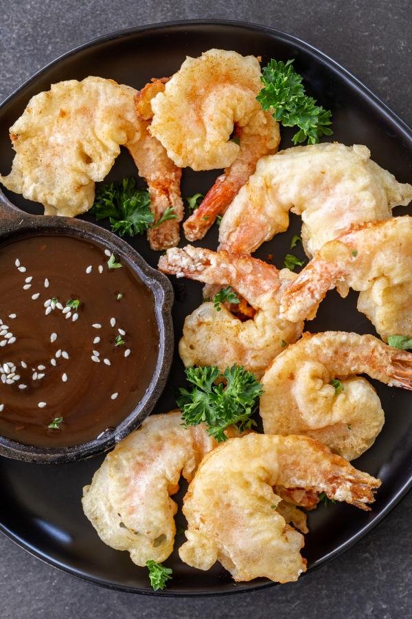 cooked shrimp on a plate with sauce