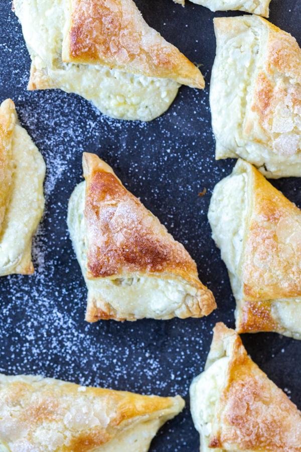 Bourekas on a tray with sugar. 