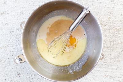 milk, eggs and yeast in a mixing bowl