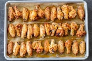 Baked chicken wings on a baking tray