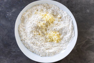 Butter in a bowl with dry ingredients.