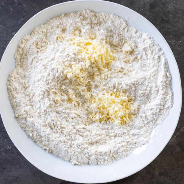 Butter in a bowl with dry ingredients.