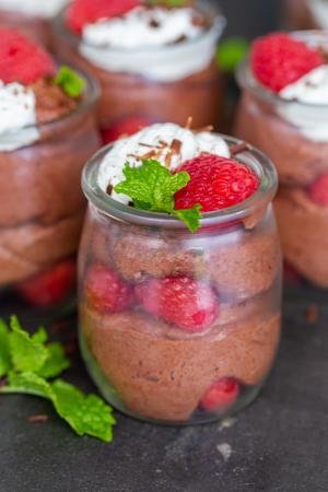 Chocolate Mousse cups with berries on top.