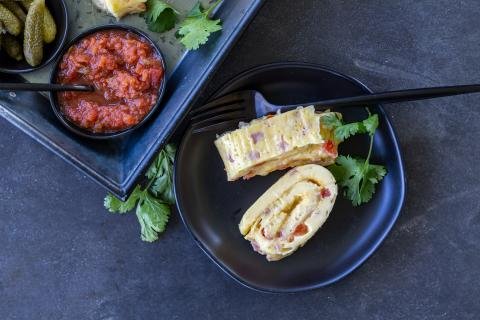 Egg Omelette Roll on a plate with a fork and salsa for dipping