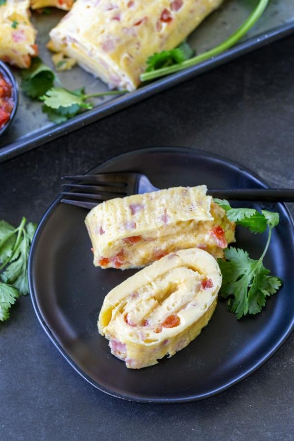 Egg Omelette Roll on a plate with a fork