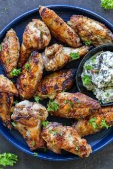 Grilled Chicken Wings on a plate with dipping sauce.