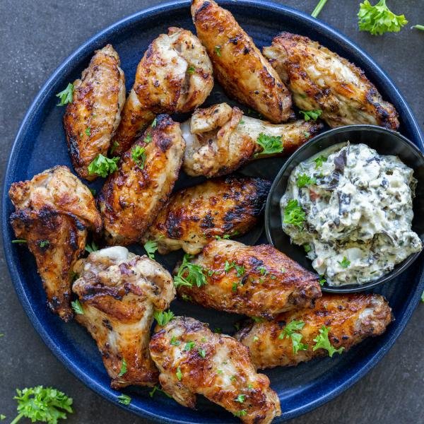 Grilled Chicken Wings on a plate with dipping sauce.