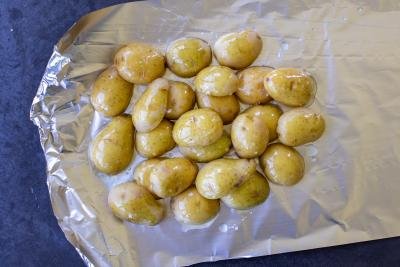Seasoned potatoes with salt and oil on top of foil