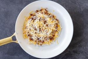 tortilla, ground beef and cheese in a pan