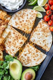Ground Beef Quesadillas on a serving tray with veggies