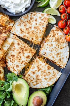 Ground Beef Quesadillas on a serving tray with veggies