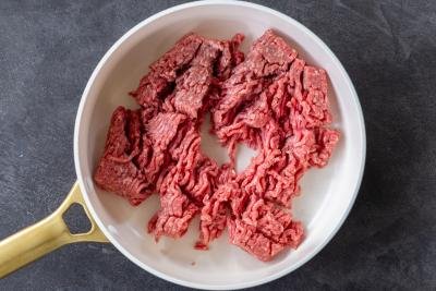 uncooked ground beef in a pan