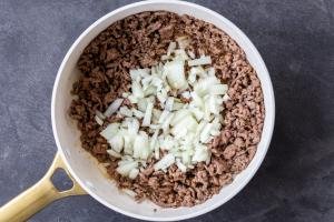 cooked ground beef with onion in a pan