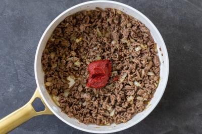 ground beef in a pan with sauce